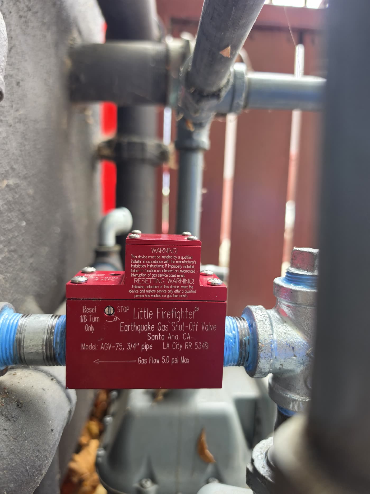 Red gas line valve connected to service piping