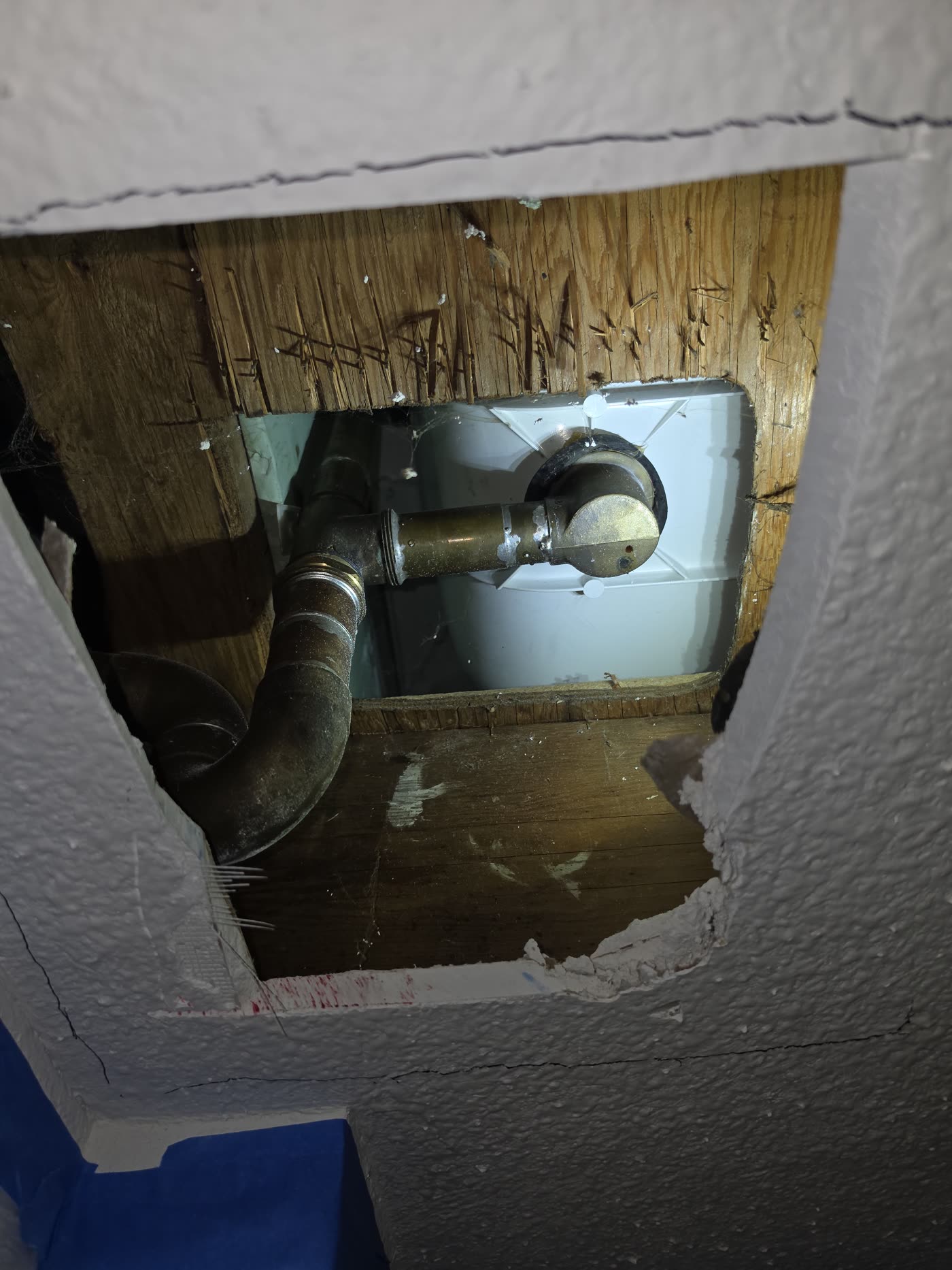 Drain pipe repair beneath a finished floor